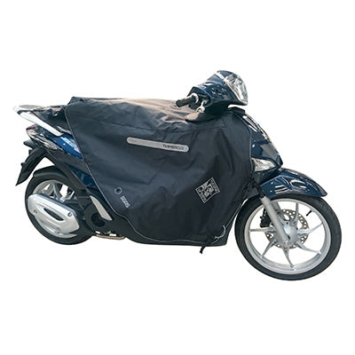 TABLIER COUVRE JAMBE TUCANO POUR PIAGGIO 50-125 LIBERTY 2016+ (R184-x) (TERMOSCUD) (SYSTEME ANTI-FLOTTEMENT SGAS)