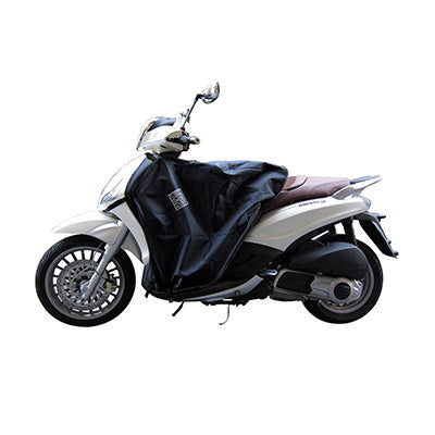 TABLIER COUVRE JAMBE TUCANO POUR PIAGGIO 125-300-350 BEVERLY (R081-X) (TERMOSCUD) (SYSTEME ANTI-FLOTTEMENT SGAS)